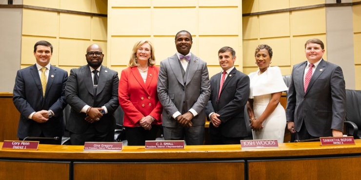 city council standing together in government plaza audtorium